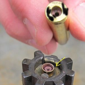 Blown primer rests on bolt face of AR15 rifle.