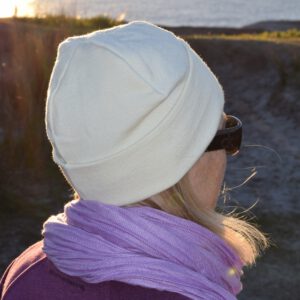 Marcus' wife Kerry on a chilly dawn coastal walk, snug in a Lindner fine wool beanie.