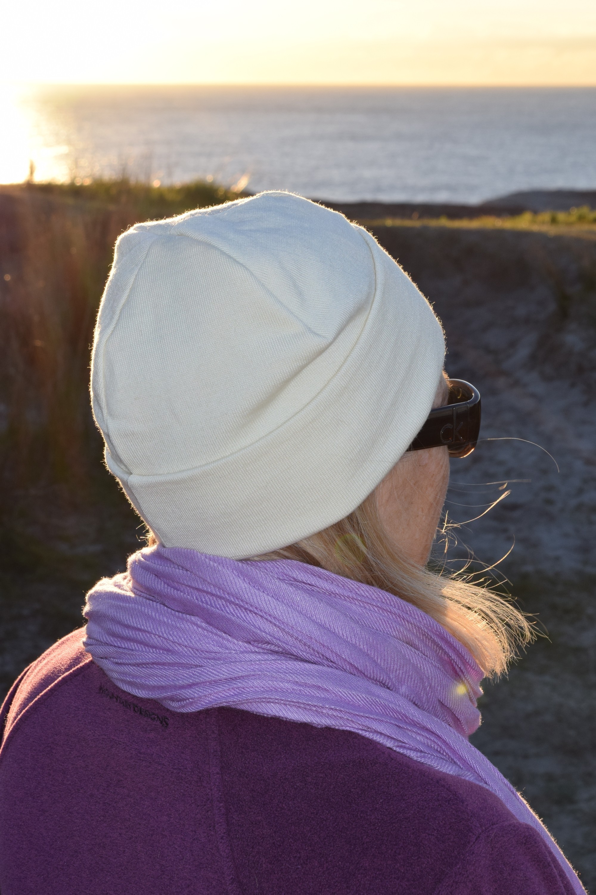 Marcus' wife Kerry on a chilly dawn coastal walk, snug in a Lindner fine wool beanie.