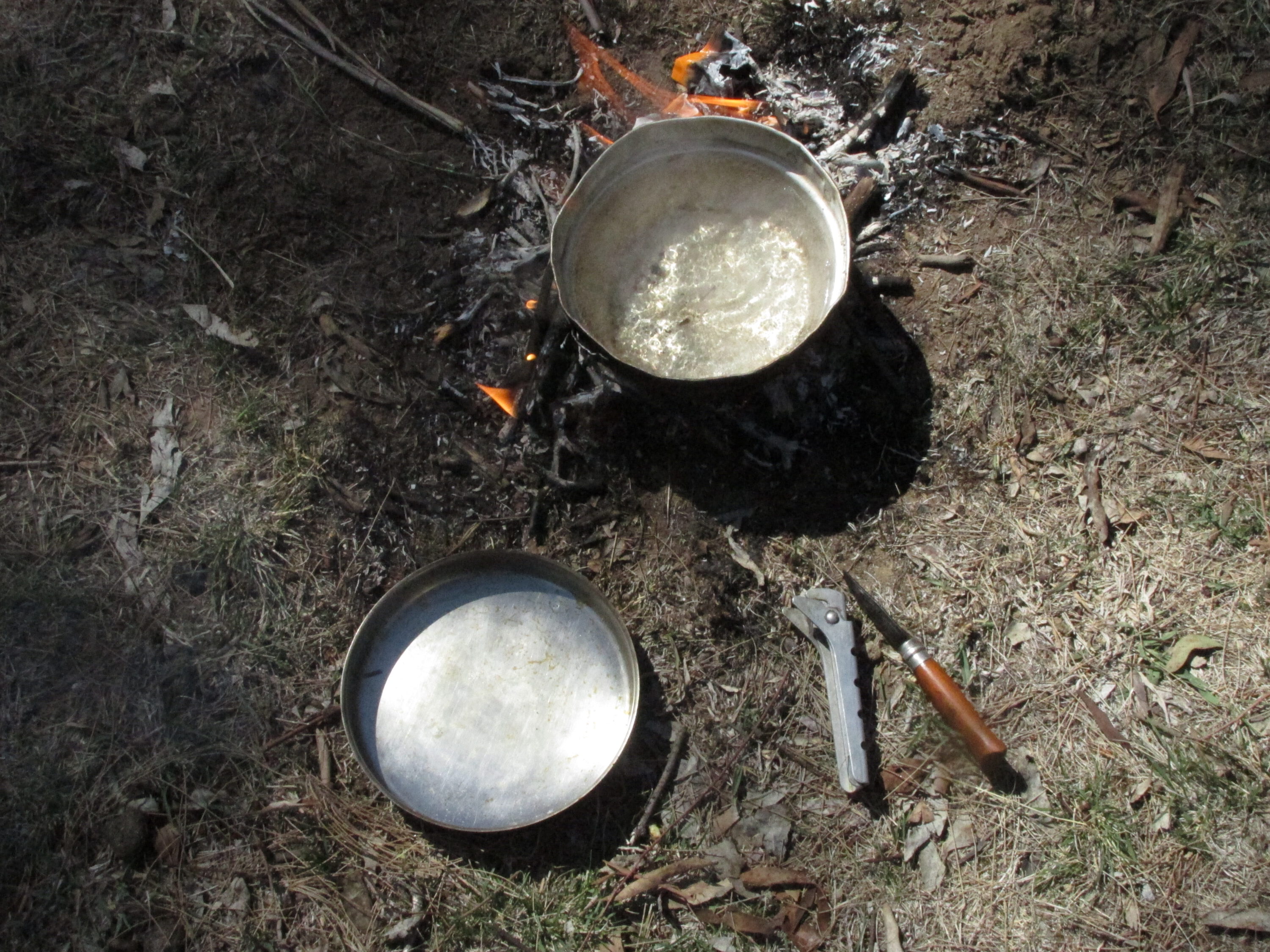 Small bushwalking aluminium stoves work well in a small hunter's camp. Billy tongs are valuable additions to the modern camper's lifestyle.